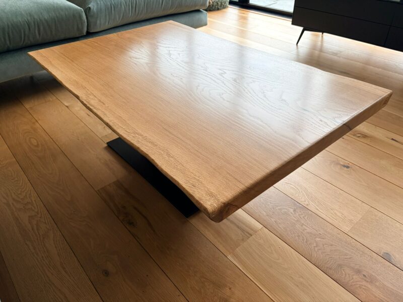 The live edge and 38mm thickness of a Timber Row French oak coffee table, seen from the side
