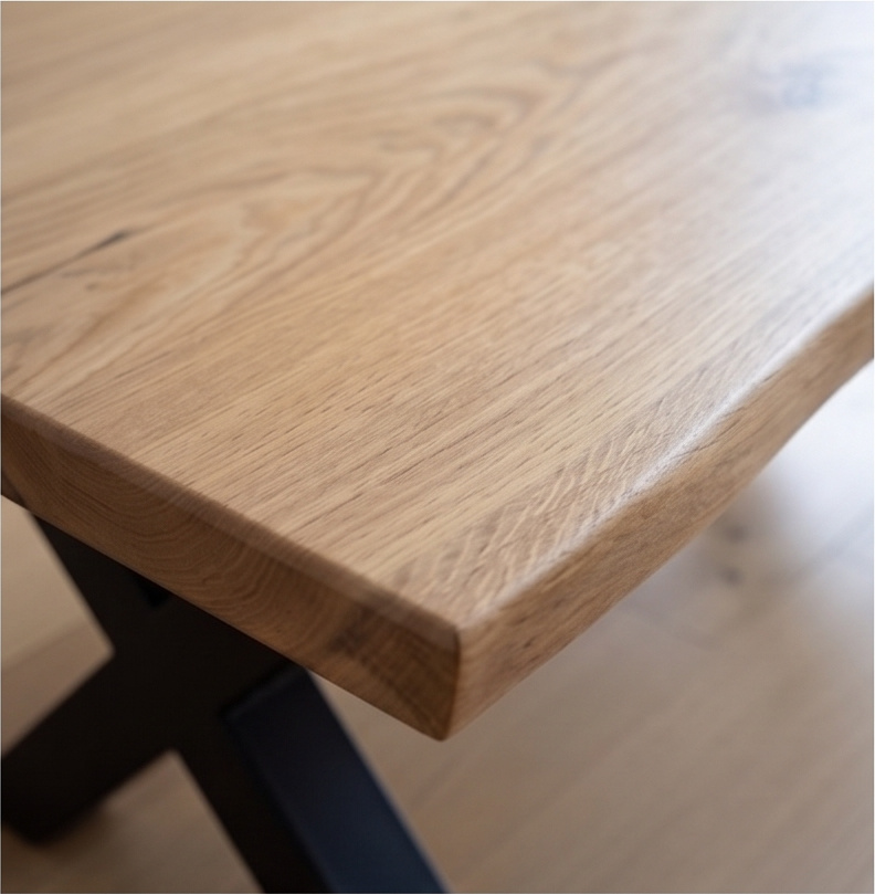 Close-up of the live edge and 37mm thickness of a French oak coffee table top on an X base