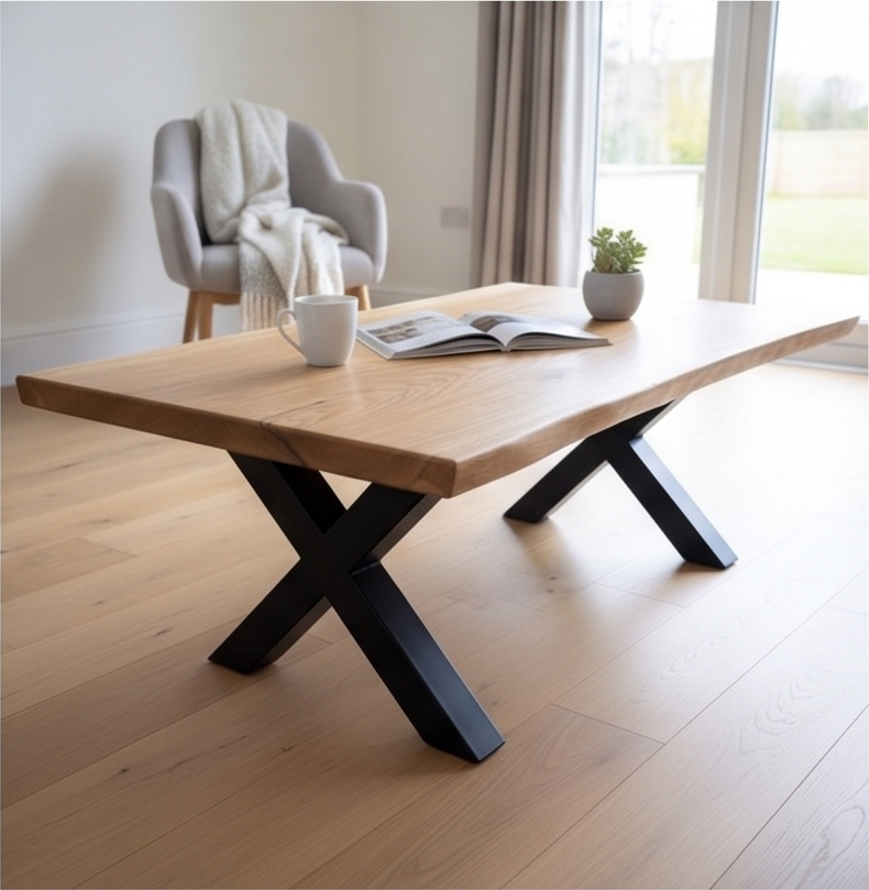 A solid French oak coffee table with a live edge and black steel X legs, in a living room