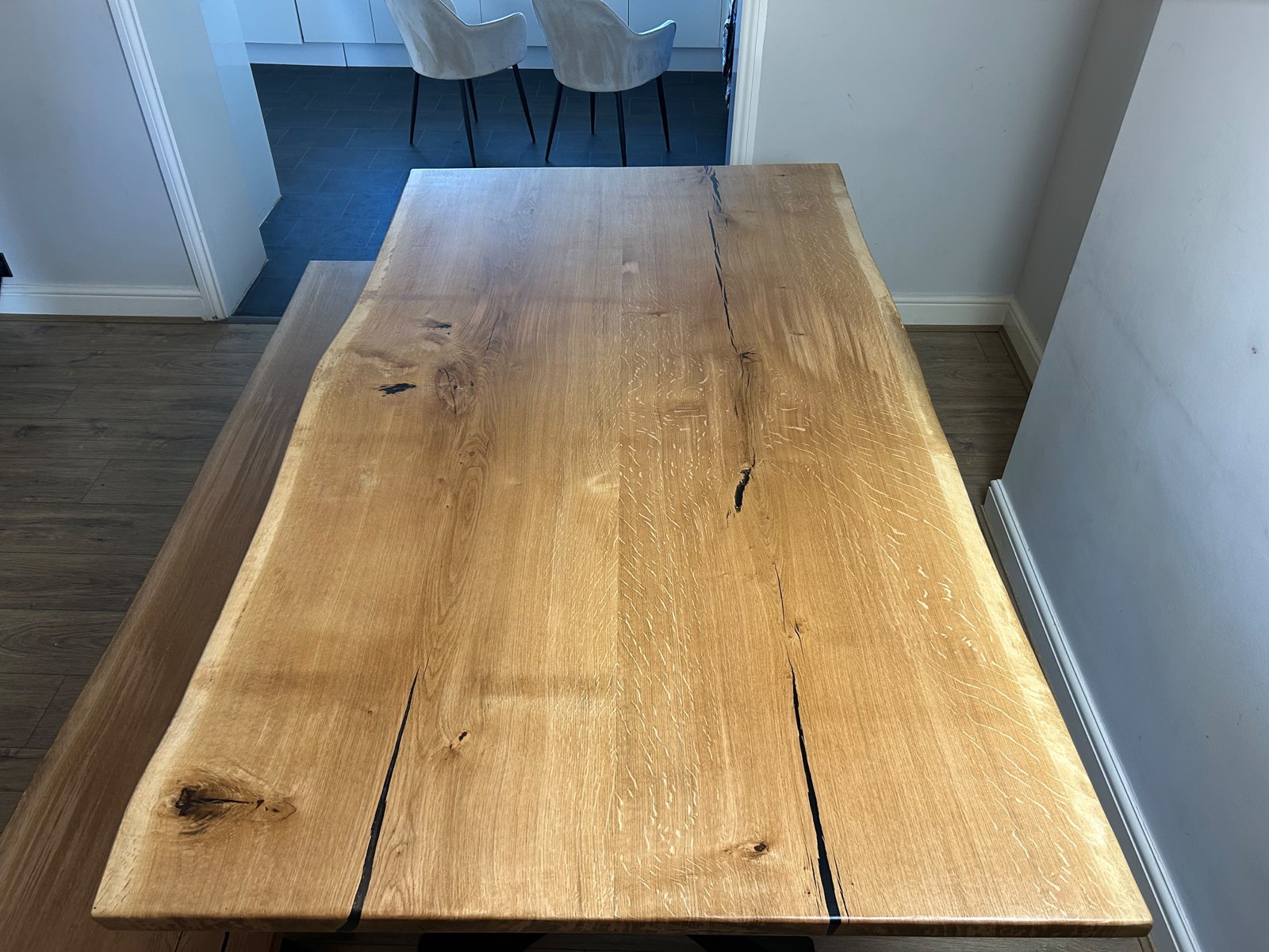 Looking along the length of the oak top towards the kitchen, live edges on both long sides