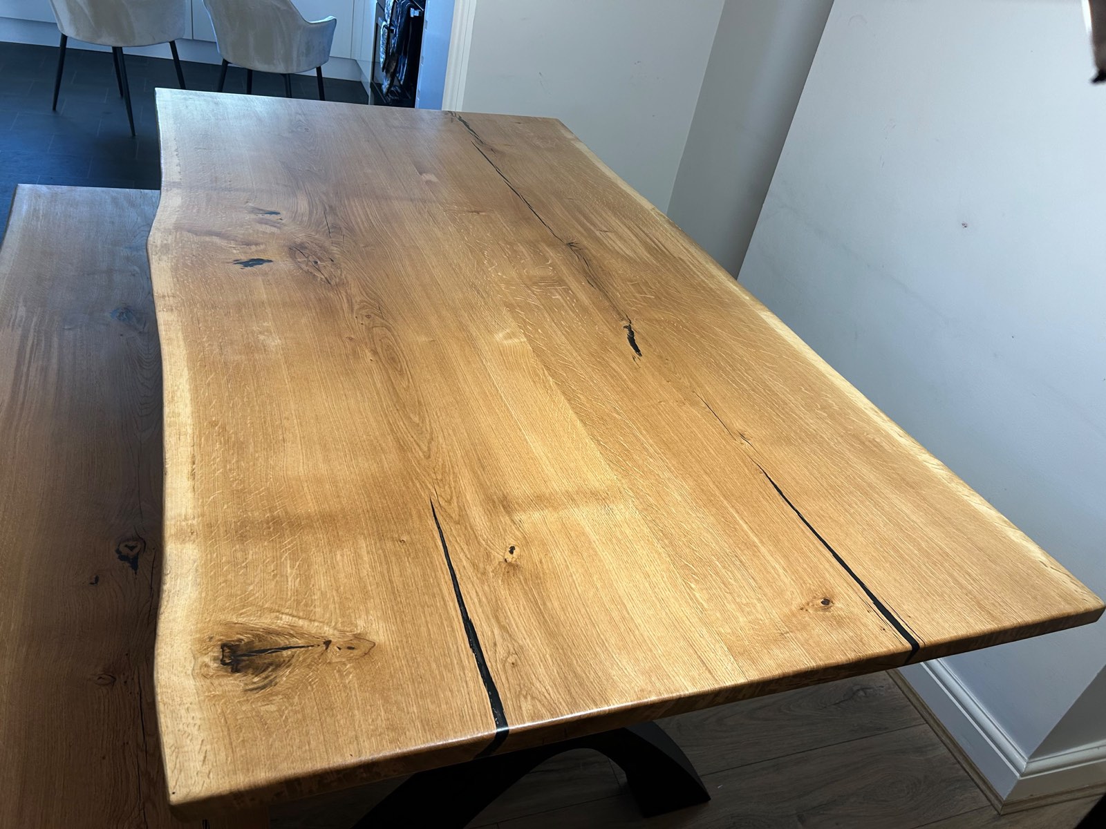 The solid oak top from the end of the table, showing the boards running its full length