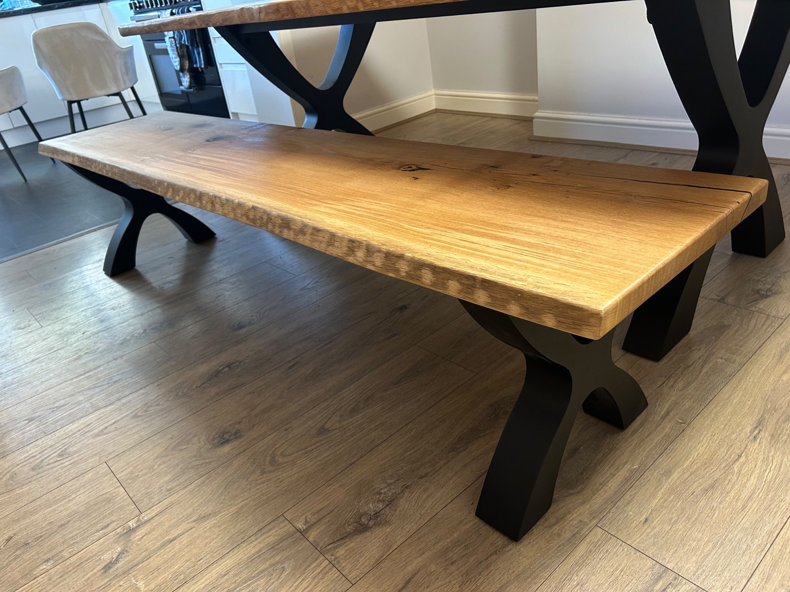 The matching solid oak bench with its own black Designer X legs and live-edge top