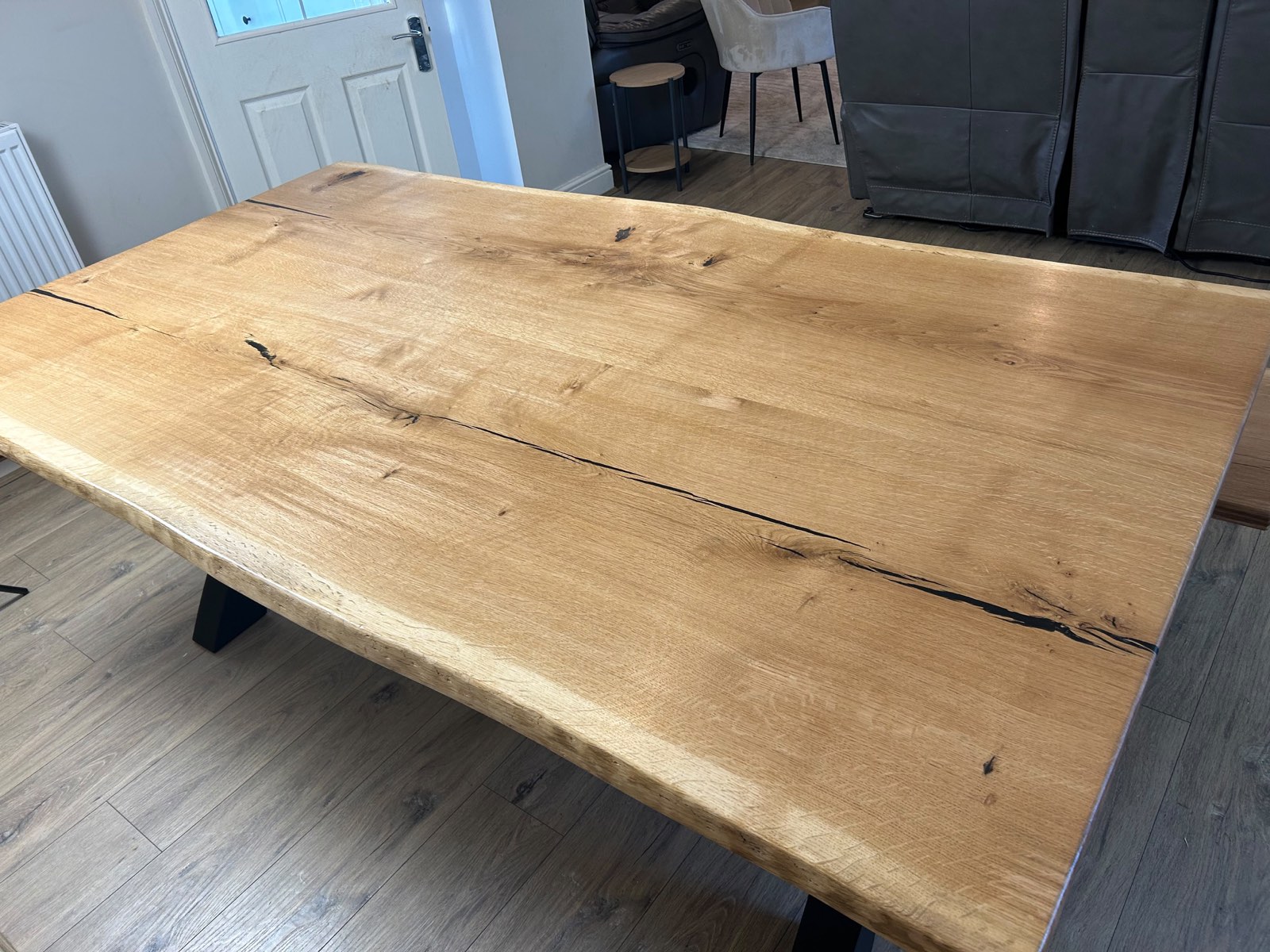 The live-edge French oak top of a customer's table, seen from above